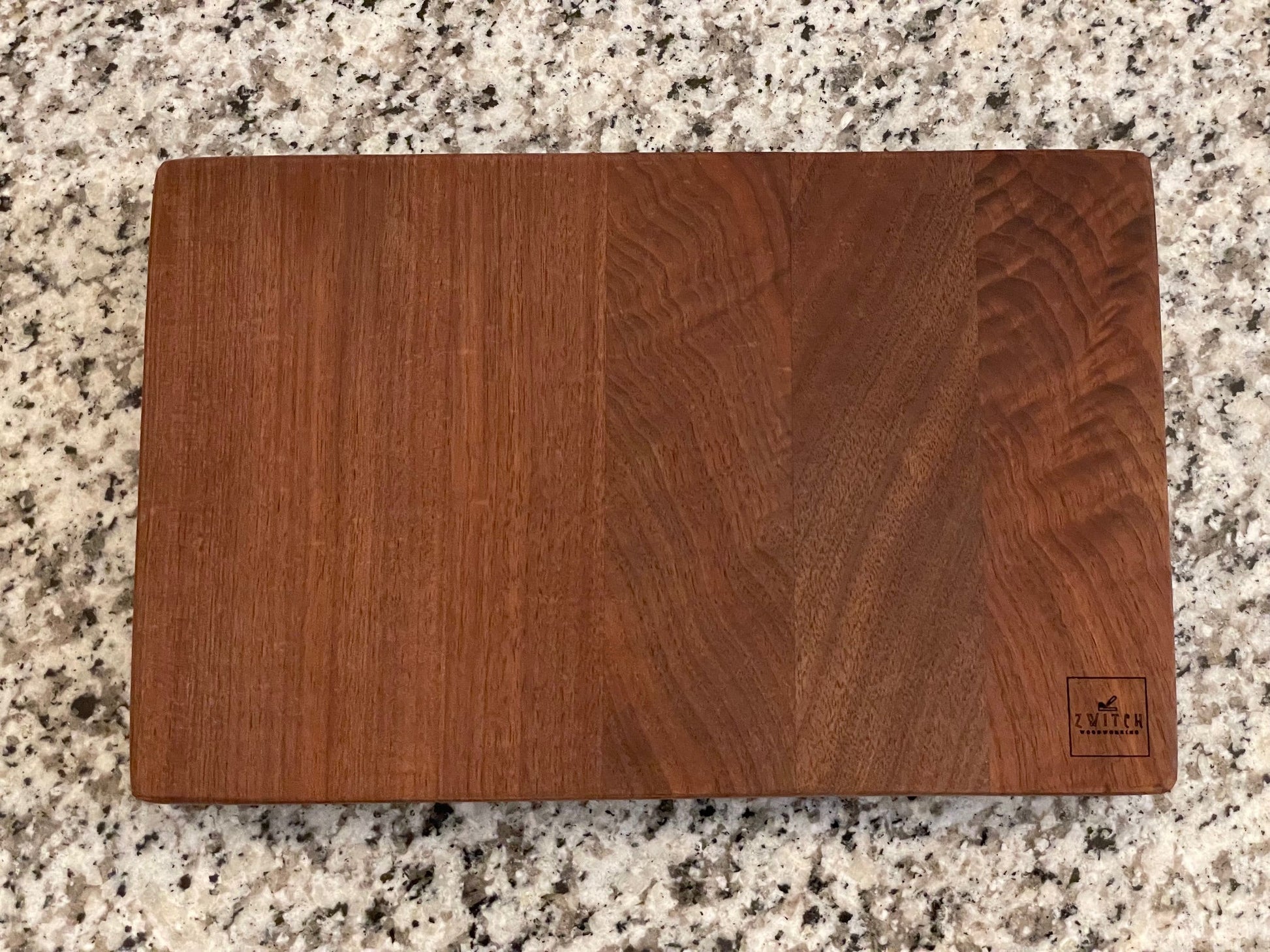 Wooden cutting board on a granite countertop